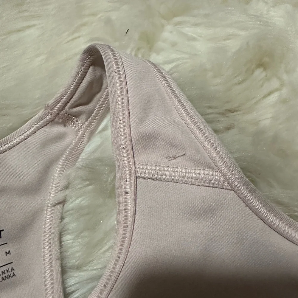 Nike Women's Light Pink Sports Bra with glitter logo. Has tiny stitch pictured!